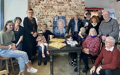 Alma sitting in the room with her family around