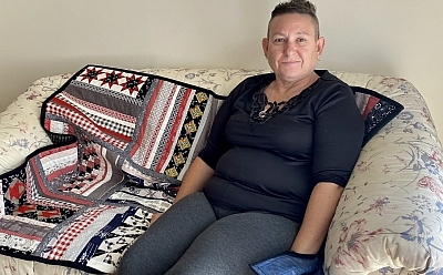 Priscilla sitting on the small white couch