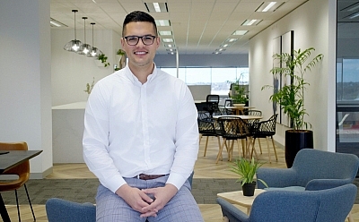 David Frost sitting in the blue chair in the office room