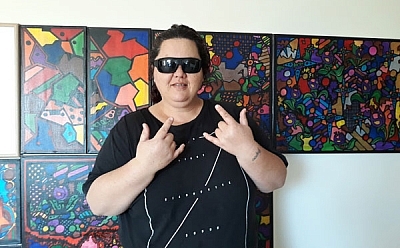 Photo of Karlene in front of her artworks