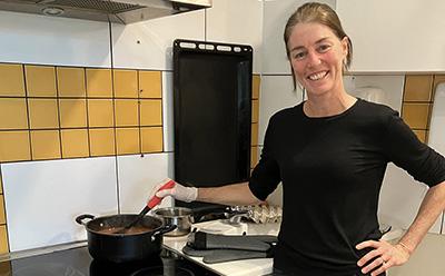 Individual-volunteering A lady cooking in a kitchen